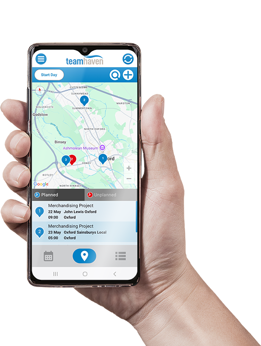 Hand holding phone showing map on TeamHaven Mobile app